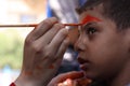 Little boy having his face painted Kids having fun playing