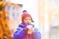 Little boy having hot drink in cold city winter Royalty Free Stock Photo