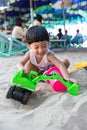Little boy having lots of fun with his toys playing in the sand outdoors. Concentrated toddler playing with his toy. child plays w Royalty Free Stock Photo