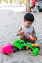 Little boy having lots of fun with his toys playing in the sand outdoors. Concentrated toddler playing with his toy. child plays w Royalty Free Stock Photo