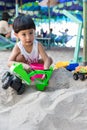 Little boy having lots of fun with his toys playing in the sand outdoors. Concentrated toddler playing with his toy. child plays w Royalty Free Stock Photo