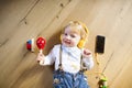 Little boy with headphones, listening music, playing musical toy Royalty Free Stock Photo