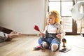 Little boy with headphones, listening music, playing musical toy Royalty Free Stock Photo