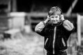 Little boy in headphones, outdoors. Black and white photo. Royalty Free Stock Photo