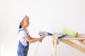 Little boy in a helmet plays in the builder with tools. isolated over white Royalty Free Stock Photo