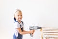 Little boy in a helmet plays in the builder with tools. isolated over white Royalty Free Stock Photo