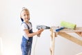 Little boy in a helmet plays in the builder with tools. isolated over white Royalty Free Stock Photo