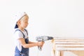 Little boy in a helmet plays in the builder with tools. isolated over white Royalty Free Stock Photo