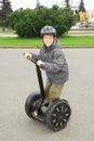 Little boy in helmet ride on segway