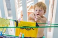 A little boy helps her mother to hang up clothes Royalty Free Stock Photo