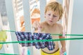 A little boy helps her mother to hang up clothes Royalty Free Stock Photo