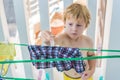 A little boy helps her mother to hang up clothes Royalty Free Stock Photo