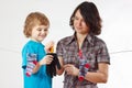 Little boy helps her mother to hang up your glove and socks Royalty Free Stock Photo