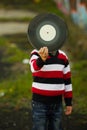 Little boy hiding behind vinyl plate