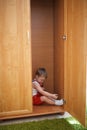 Little boy hiding in closet