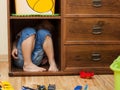 Little boy hiding in a cupboard Royalty Free Stock Photo