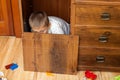 Little boy is hiding in the cupboard Royalty Free Stock Photo