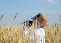 Little boy hiding in a wheat field bird watching