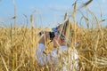 Little boy hiding in a wheat field bird watching