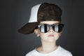 Little boy.Hip-Hop Style. fashion children.handsome in sunglasses.in Tracker Hat Royalty Free Stock Photo