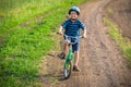 Little boy with his bike in hands on country road Royalty Free Stock Photo