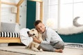 Little boy with his dog in stylish bedroom Royalty Free Stock Photo