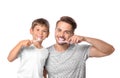 Little boy and his father brushing teeth on white background Royalty Free Stock Photo