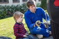 Little boy and his father changing wheel on car Royalty Free Stock Photo