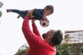 Little boy and his father enjoying playing together with a soccer ball outdoors. Royalty Free Stock Photo