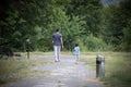 Little boy and his father enjoying warm summer day. Parent and pupil going to kindergarten of preschool. Active family walking in