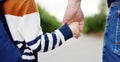 Little boy with his father going to school after summer break. Close-up photo of child and parent hands. Education for little kids Royalty Free Stock Photo