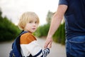 Little boy with his father going to school after summer break. Education for little kids