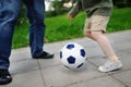 Little boy with his father having fun playing a soccer game on sunny summer day Royalty Free Stock Photo