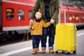 Little boy and his father waiting express train on railway station platform Royalty Free Stock Photo