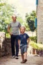 Little boy with his father walk together