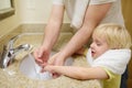 Little boy and his father washing their hands with soap in bathroom together. Hygiene for little child Royalty Free Stock Photo