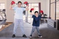 Little boy and his father wear boxing gloves