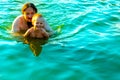 The little boy in his father's arms, in the waves of the sea. Dad with the little child on vacation. Royalty Free Stock Photo