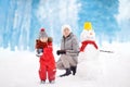 Little boy with his mother/babysitter/grandmother playing snowball fight in snowy park Royalty Free Stock Photo