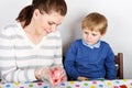 Little boy and his mother being happy about selfmade Easter eggs Royalty Free Stock Photo