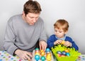 Little boy and his mother being happy about selfmade Easter eggs Royalty Free Stock Photo