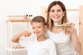Little boy and his mother brushing teeth in bathroom Royalty Free Stock Photo