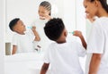 So up and down and round and round. little boy and his mother brushing their teeth together in a bathroom at home. Royalty Free Stock Photo