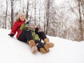 Little boy with his mother enjoy riding on ice slide in winter Royalty Free Stock Photo