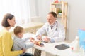 Little boy with his mother at paediatrician on consultation Royalty Free Stock Photo