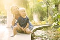 Little boy with his mother sitting near the fountain Royalty Free Stock Photo