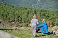 Little boy with his mother spending a day in nature relaxing and watching the cows graze Royalty Free Stock Photo