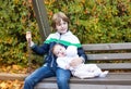 Little boy and his newborn baby sister on swing Royalty Free Stock Photo