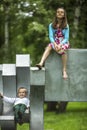 Little boy with his older sister on the Playground in the Park. Fun. Royalty Free Stock Photo