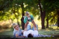 Little boy with his parents lying down on the grass